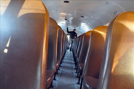 Montana Highway Patrol Trooper Shad Andersen inspects the Ronan fleet of school buses.