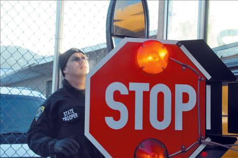 Montana Highway Patrol Trooper Shad Andersen inspects the Ronan fleet of school buses.