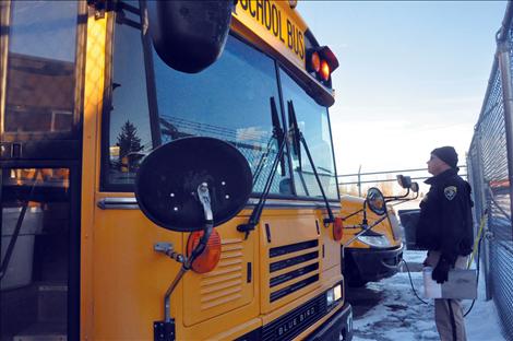 Montana Highway Patrol Trooper Shad Andersen inspects the Ronan fleet of school buses.