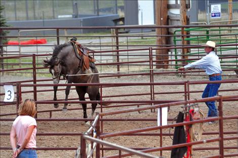 Jim Davis deals with a bucking colt in the Round Pen Shootout in Ronan. 