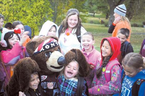 A gaggle of excited Ronan students surrounds Monte, the Griz mascot, who made the trip to Ronan for the annual Ronan Walks and Rolls event Oct. 3.
