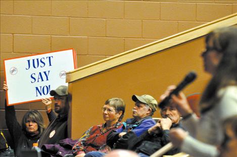 Irrigators listen and hold signs during an informational meeting about the Confederated Salish and Kootenai Tribes Water Compact, that the Montana Reserved 