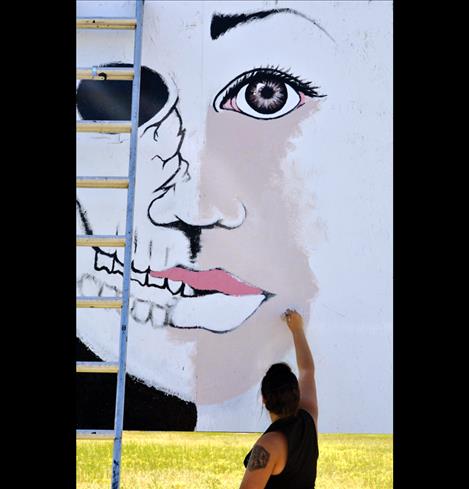 Briar Ahlborn paints an anti-methamphetamine billboard along Highway 93 near St. Ignatius for Montana Meth Project’s Paint the State contest.