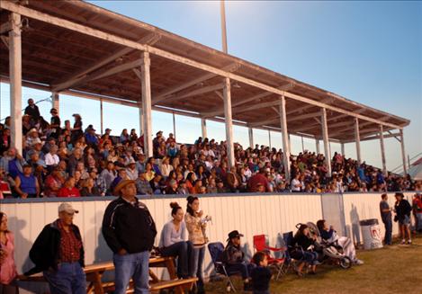 Spectators watch the United Indian Rodeo Association rodeo from the grandstands at the Polson fairgrounds. The grandstand seats, decks and walkways will be replaced with a grant received by Polson Fairgrounds Inc.