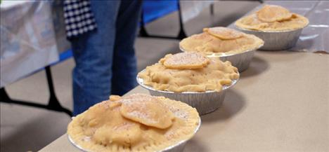 Topped with a pastry apple and a sprinkle of cinnamon and sugar, 6-inch pies are ready to be boxed and frozen.