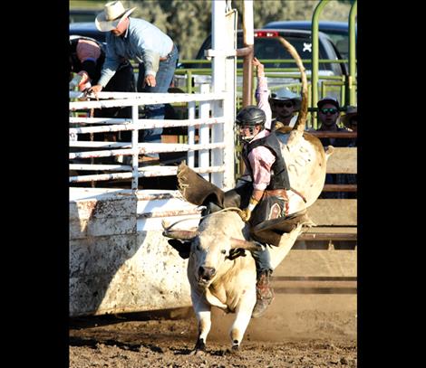 Tanner Heidegger, Kalispell, above, rides one of the tough bulls at the Wiliam Cleveland benefit.