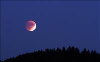 Blood moon casts  crimson glow