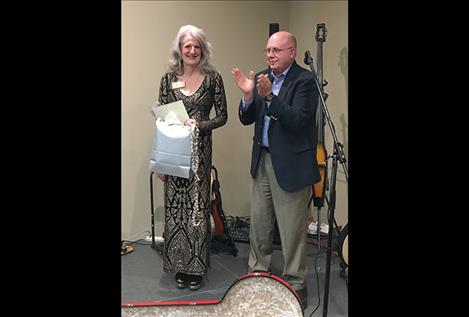 Twentieth Judicial District Judge Deborah Kim Christopher, left, president of the Montana Judges Association, is honored by retired District Court Judge and former Association president Mike Salvagni.