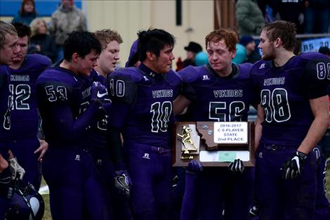 Charlo players keep their poise as they accept the second-place state trophy Saturday at Halgren Field.