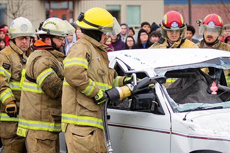 A Ronan fire-rescue team uses “Jaws of Life” during the Ghost Out event.