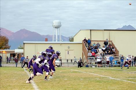 The Charlo Vikings move the ball down the field with a high kick. 