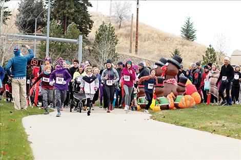 Runners take off at the start of the 5k Turkey Trot on Thanksgiving Day.