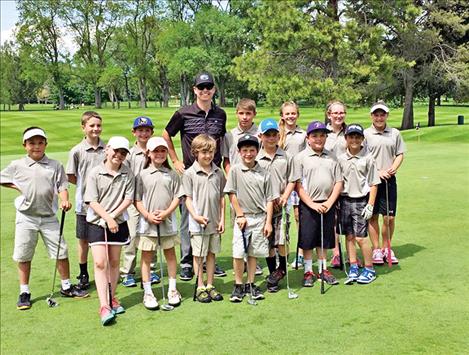 Cameron Milton coaches a group of young golfers in Polson. 