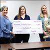 Simply406 owner Amy Kellogg, Jeneva Lunceford and Heather Knutson-Walter make a donation to Two Eagle River school for the purchase of a washer and dryer.