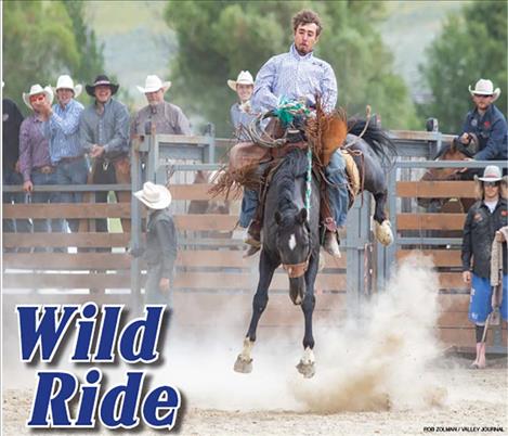 Arlee cowboy Lane Schall competes in bronc rodeo action and holds on for a 73-point ride and top-prize money.