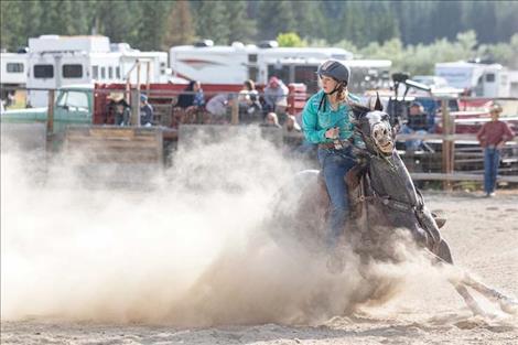 Charlo cowgirl Morgan Shepard stirs up some dust during the barrel race on Sunday.