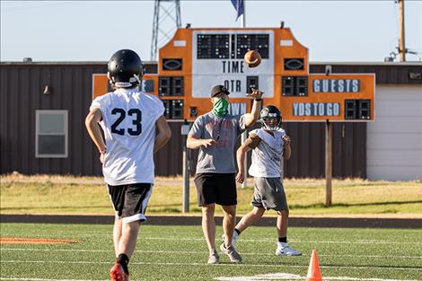 Ronan Chief's head football coach Matt Detwiler throws a pass to his running back. 