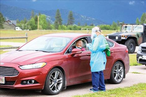 Tribal elder Stephen Small Salmon prepares for a COVID-19 test, administered by RN Kristin Murphy during a  Confederated Salish and Kootenai Tribal Health testing event held earlier this year.