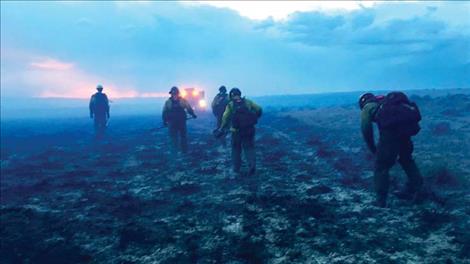 A Bureau of Land Management wildland fire crew works a fire in Montana during the record-setting 2017 fire season.