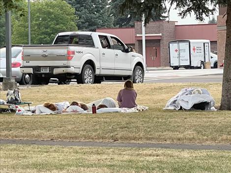 Evacuees sleep in the grass early sunday morning outside the linderman gym. The gym is being used as a shelter for those displaced by the Boulder fire