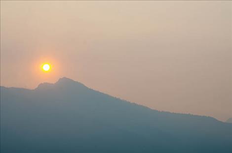 Smoke from wilderness fires blankets the Mission Mountain sunrise.