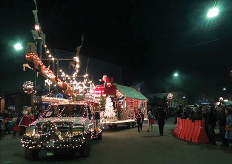 Santa Claus waves from atop a float in Polson’s 2019 Parade of Lights.