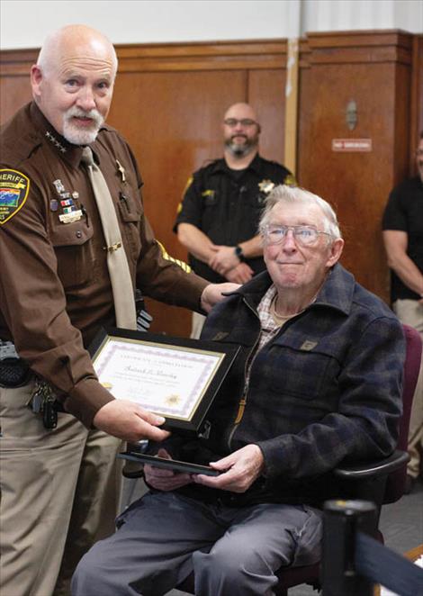 Lake County Sheriff Don Bell presents Rod Wamsley with a certificate of appreciation for half a century of service to the sheriff’s office.