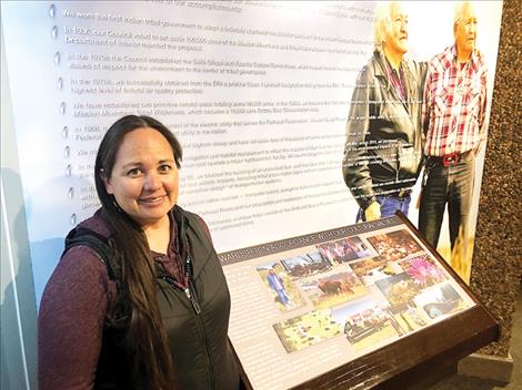 Stephanie Gillin, information and program manager for the Natural Resources Division who curated the Visitors’ Center display, stands near a photograph of her grandmother and inspiration, Felicity McDonald, as well as other tribal elders.
