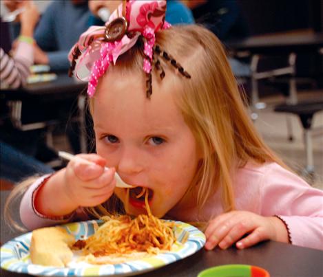 Brinley Jennison spoons in some spaghetti at the benefit.