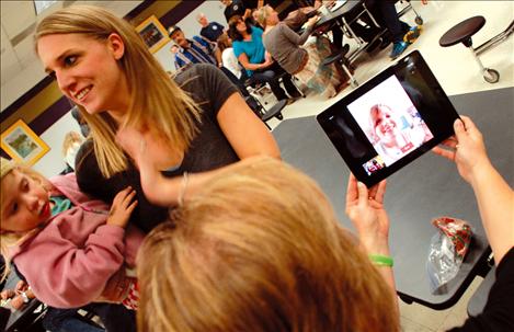 Debbie Jones, grandmother of both Bella and Bridger, speaks with daughter Breanna vis iPad while Jessica Allred, left, hangs out with Jazmyn, Bella’s younger sister.