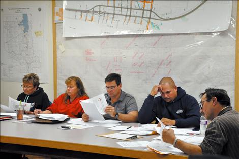 Marlene Melton, Ellen Kaphammer, Cal Hardy, Robert McCrea, and Kim Aipperspach look over budget documents at a Sept. 30 meeting.