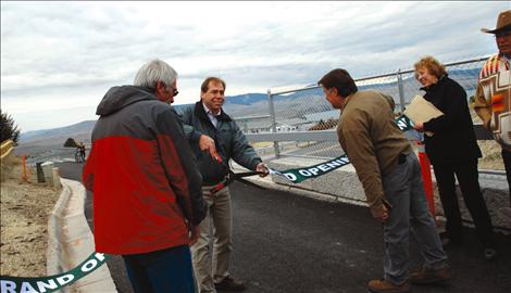 Mitch Stelling, center, engineer for the Skyline Drive project, cut the ribbon opening Skyline with help from former Lake County Commissioner Paddy Trusler, Roland Godan, Billie Lee and Lloyd Irvine. The grand  opening was held on Oct. 12.