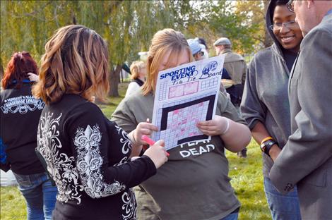 Samantha Darr and Shaelee Hansen mark off places in pig pie bingo.