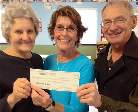 Kathy Gallagher and Alice Gleason present a $15,000 check to John Schnase, executive director of the Boys and Girls Club, so Club members can take swim lessons at Mission Valley Aquatic Center.
