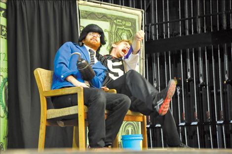Daniel Prillman of the National Children’s Theater plays a loan shark preying on a hapless teen, played by Sam McCalla, purchasing his first car. The duo performed the Mad About Money show to Ronan Middle School students. 
