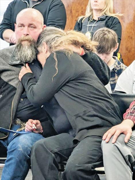 Sharline Clairmont-McFarland, mother of Rozlyn Paige Bluemel, is comforted by her husband Adam during the sentencing of her daughter’s killer. 