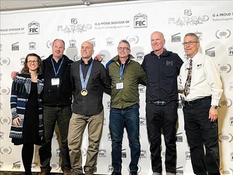 FLIC event organizers and film producers Jessica and David King (far left and right) stand with Mavericks film director Scott Sterling, 1998 Olympic Gold Medalist Eric Bergoust (freestyle skiing - men’s aerials), Mavericks writer/producer Kelly Gorham and Montana skier Joe Chalmers. Mavericks, which documents Montana’s freestyle ski legacy, won Best Documentary Feature.
