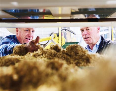 Gov. Gianforte, pictured with ranch owner Joel McCafferty, views the feed produced by the hydroponic plant at McCafferty Ranch.