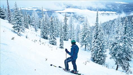 A skier looks toward Whitefish Lake from the slopes of Big Mountain on Feb. 19, 2023. 