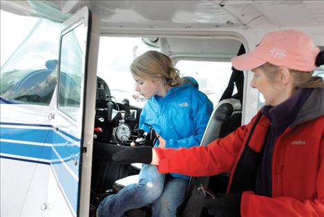 Young Eagle Brenna McGuinness asks pilot Carmine Mowbray about the compass on Mowbray’s plane. 