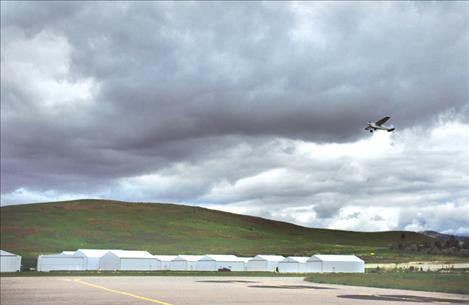 Clouds move in during the late morning as a pilot takes another load of Young Eagles up for a ride on June 9. 