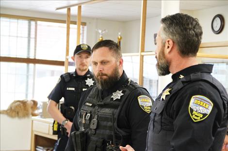 Chief Jacobson (right) acknowledges Officers Barber (left) and Gililand (middle). 