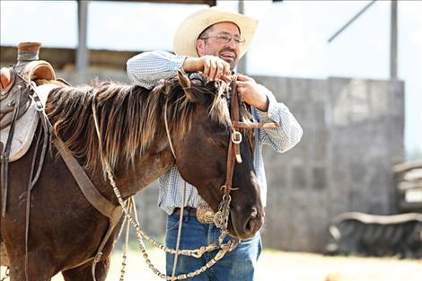 Ranch host Josh Senecal demonstrates the proper way to bridle a horse.