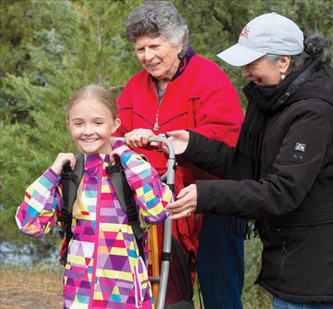 Fourth grader Anna Fansher demonstrates for her classmates how bringing an overly large pack isn’t a good idea when hiking or camping.