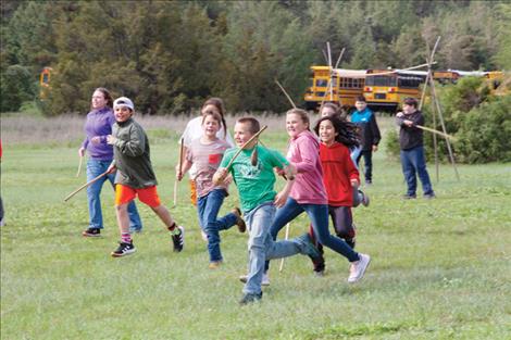 Ethan Homola, green shirt, and fellow students in Valerie Rogers’ fifth grade Polson Middle School class play a rousing game of double ball.