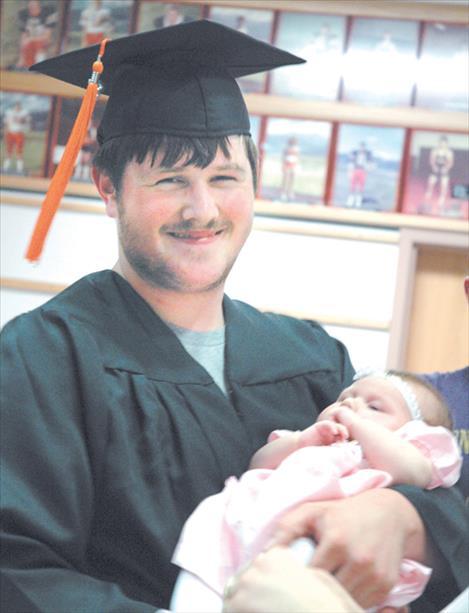 Brandon Hakes smiles for a photo while holding his two-month-old baby girl, Hailey. The photo was taken at the 2005 Ronan High School graduation - the first year graduations were covered by the Valley Journal newspaper. 