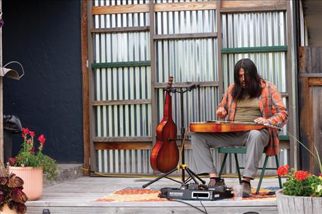  Live music played by local musician Dan Debuque  filled a spacious outdoor gathering area. 