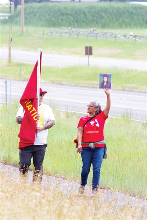 Bonnie Asencio holds up a picture of her daughter, Maurena “Mena” Twoteeth who was was killed alongside US Highway 93 near St. Ignatius last year.