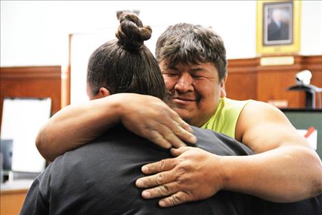 Michael Pierre Sr. embraces Drug Court Coordinator Dana Comes At Night, a who supported him throughout his journey to graduation.