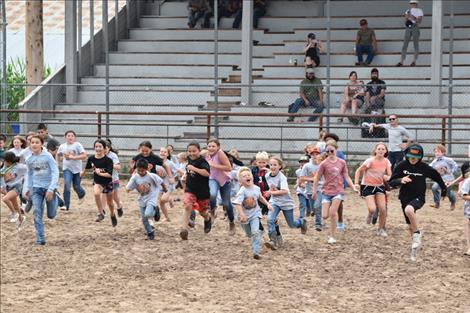 Kids take off to capture a chicken during the chicken scramble.